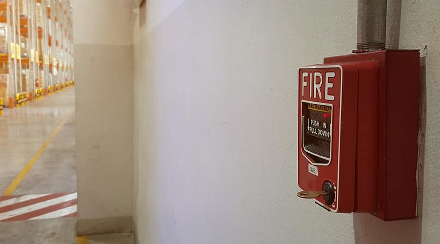 fire alarm on a wall in a warehouse